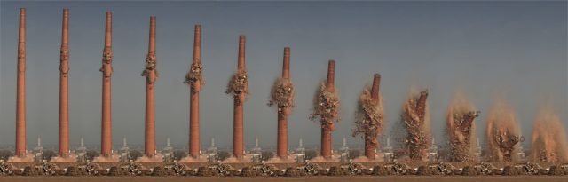 Controlled demolition of a tall smokestack.